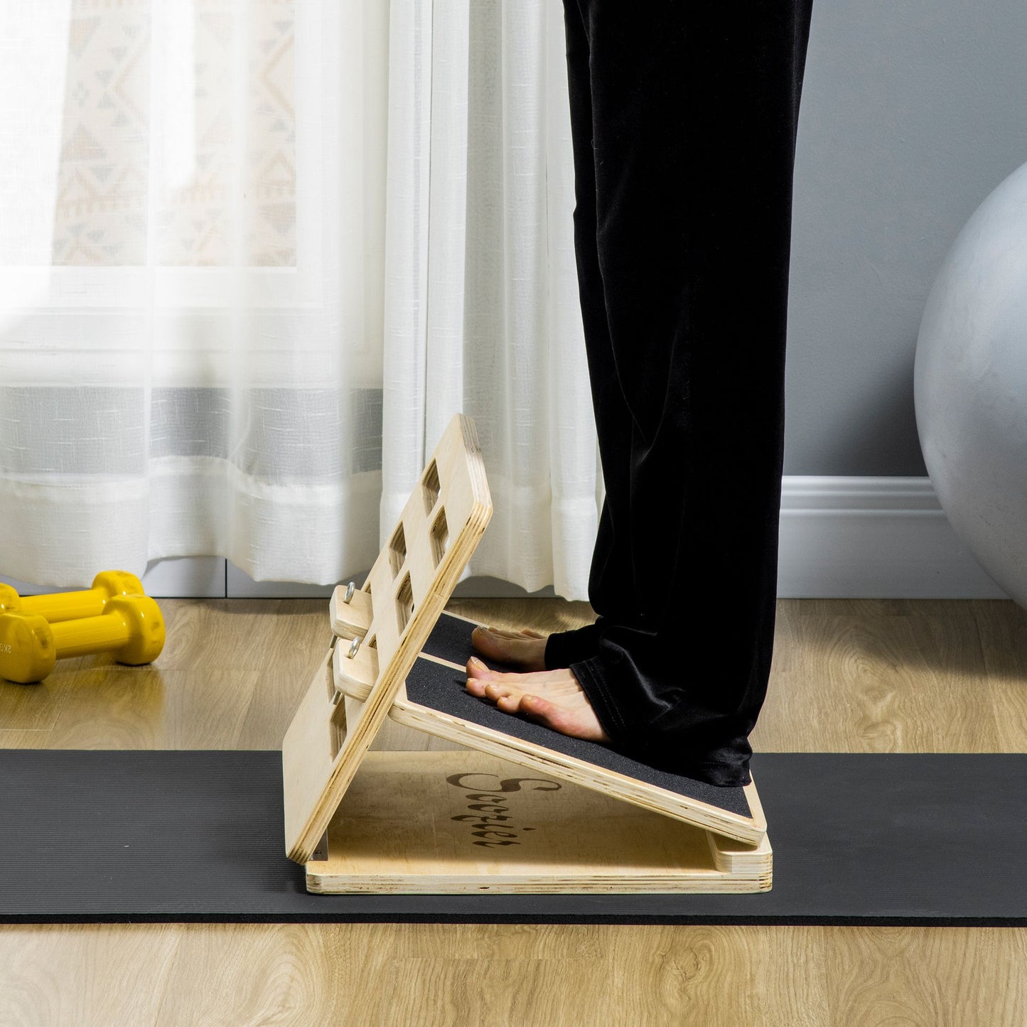 Person using a wooden step platform on a mat in a home setting