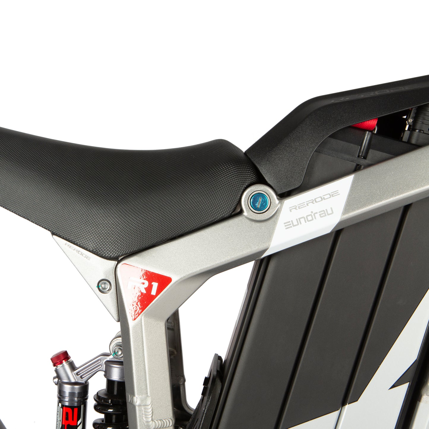 Close-up of a motorcycle seat and frame with 'R&G Racing' branding on a white background.