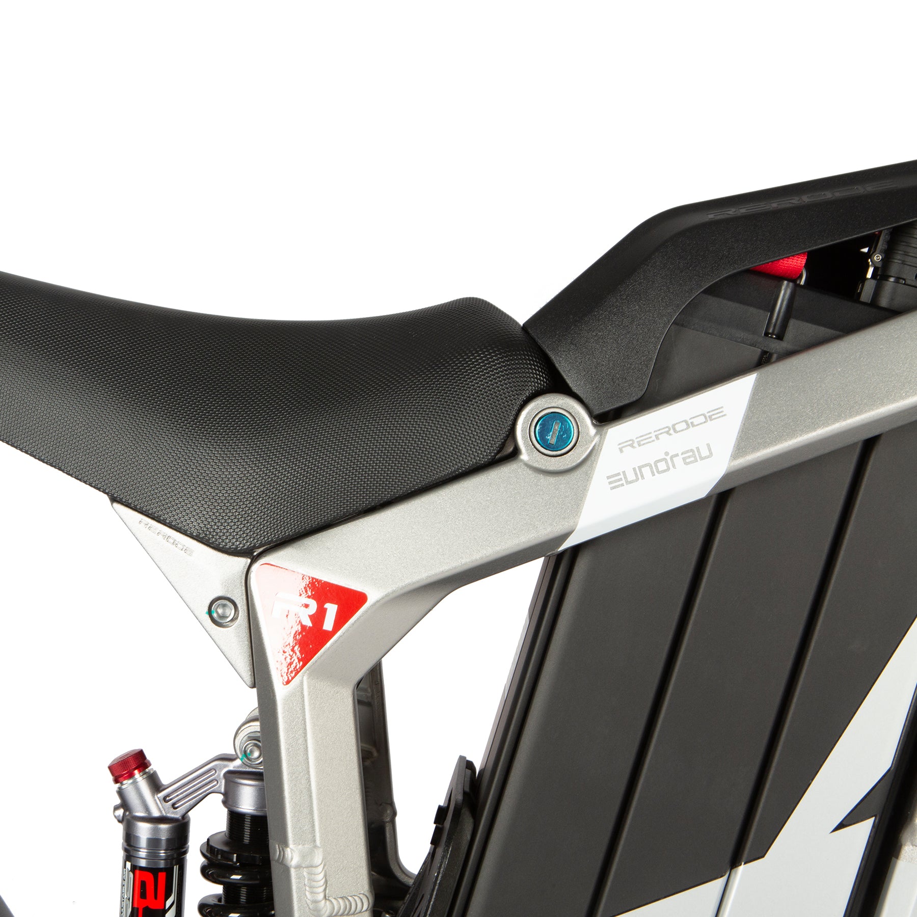 Close-up of a motorcycle seat and frame with 'R&G Racing' branding on a white background.