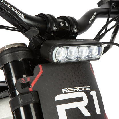Close-up of a Rerode electric bike handlebar with LED light and 'R1' branding.