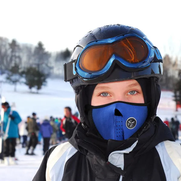 Person wearing a blue helmet and face mask in a snowy outdoor setting