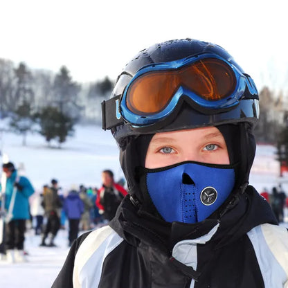 Person wearing a blue helmet and face mask in a snowy outdoor setting