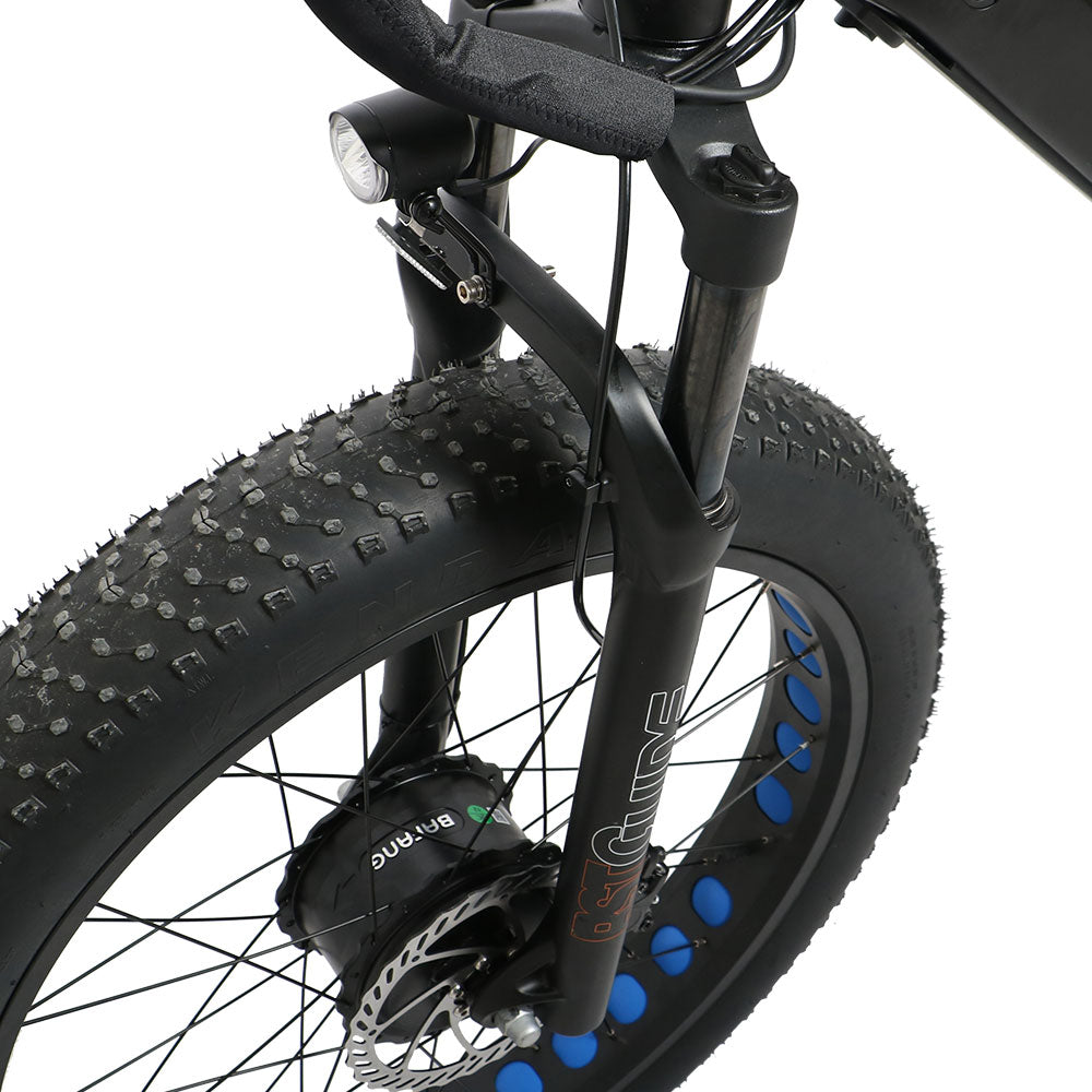 Close-up of a bicycle wheel with knobby tires on a white background