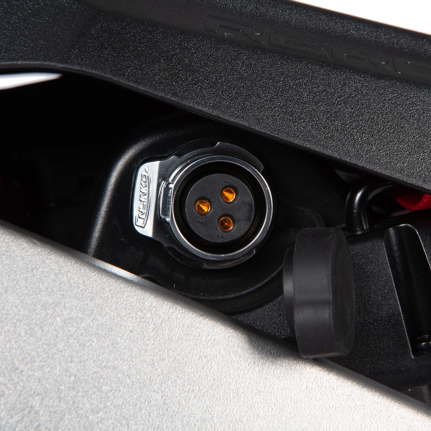 Close-up of a black electrical connector with visible brand logo on a gray background