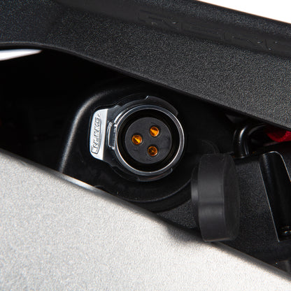 Close-up of a black electrical connector with visible brand logo on a gray background