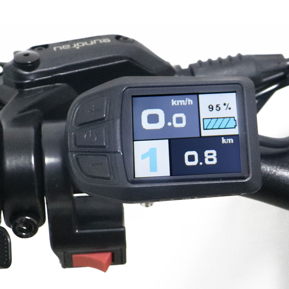 Close-up of a motorcycle dashboard with digital display on a white background