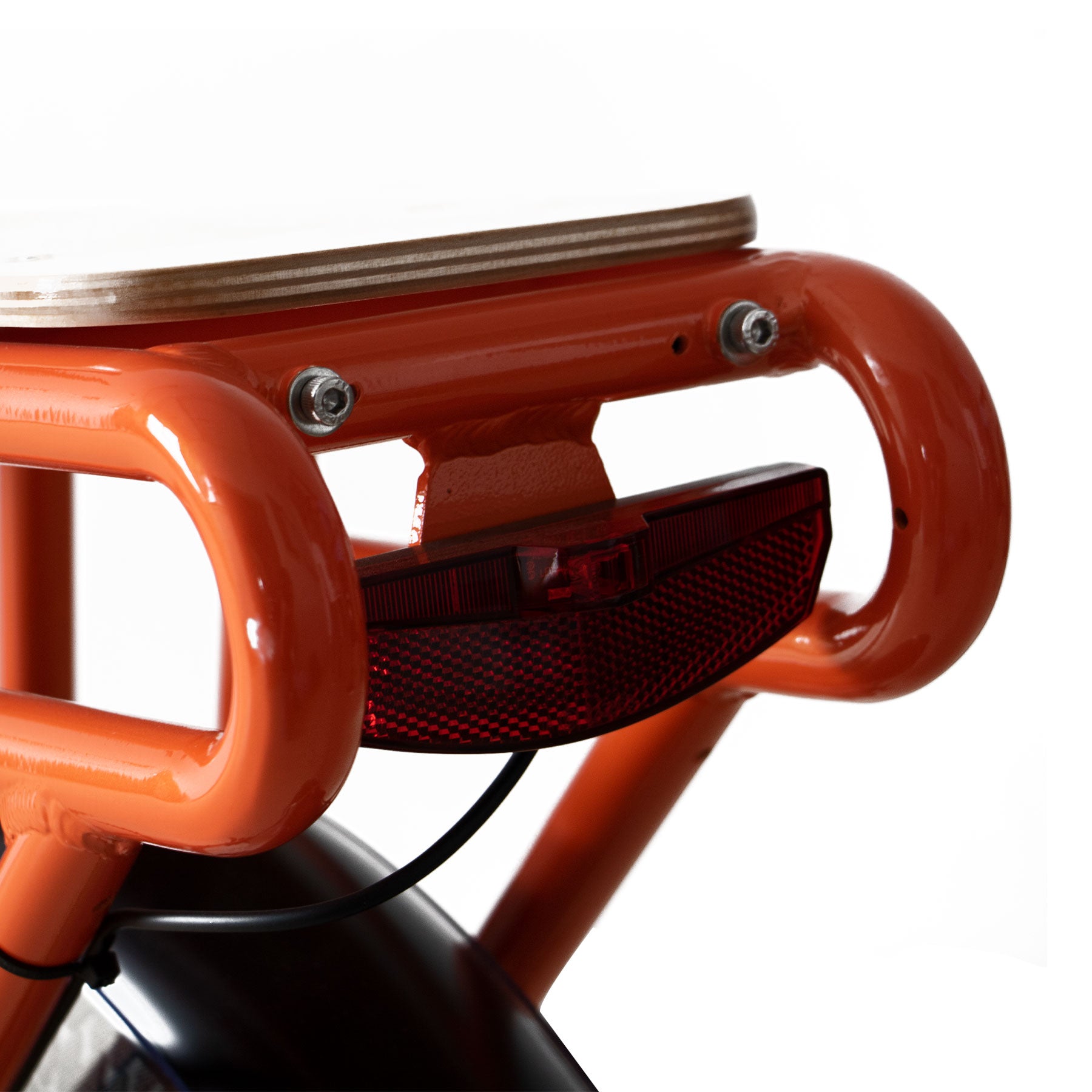 Close-up of an orange metal stool with a white background