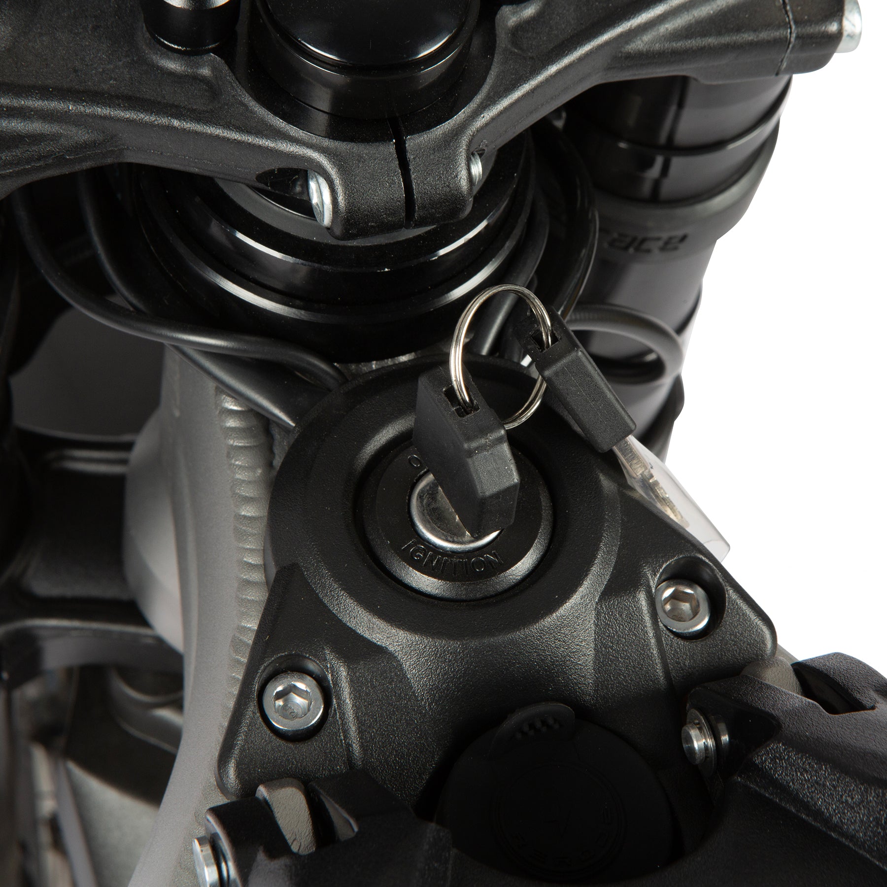 Close-up of a motorcycle engine with a key inserted into the ignition.