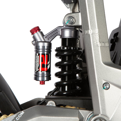 Close-up of a motorcycle suspension system with visible branding on a white background