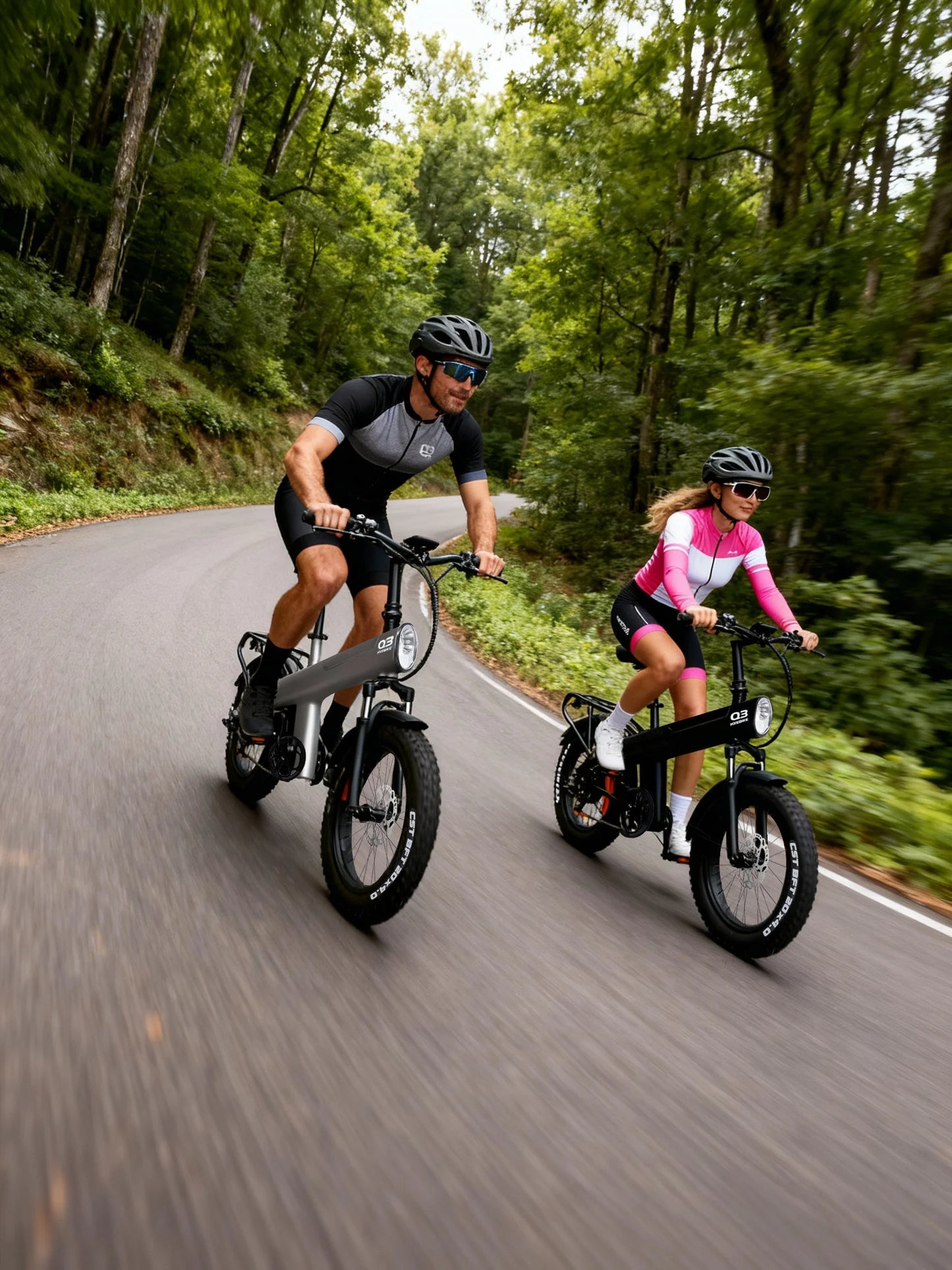 Two people riding electric bikes on a forest road