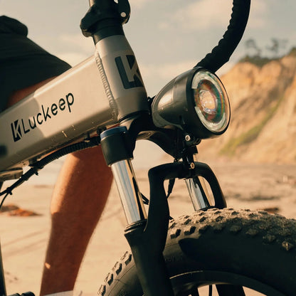 Close-up of a Luckeep electric bike with a scenic background