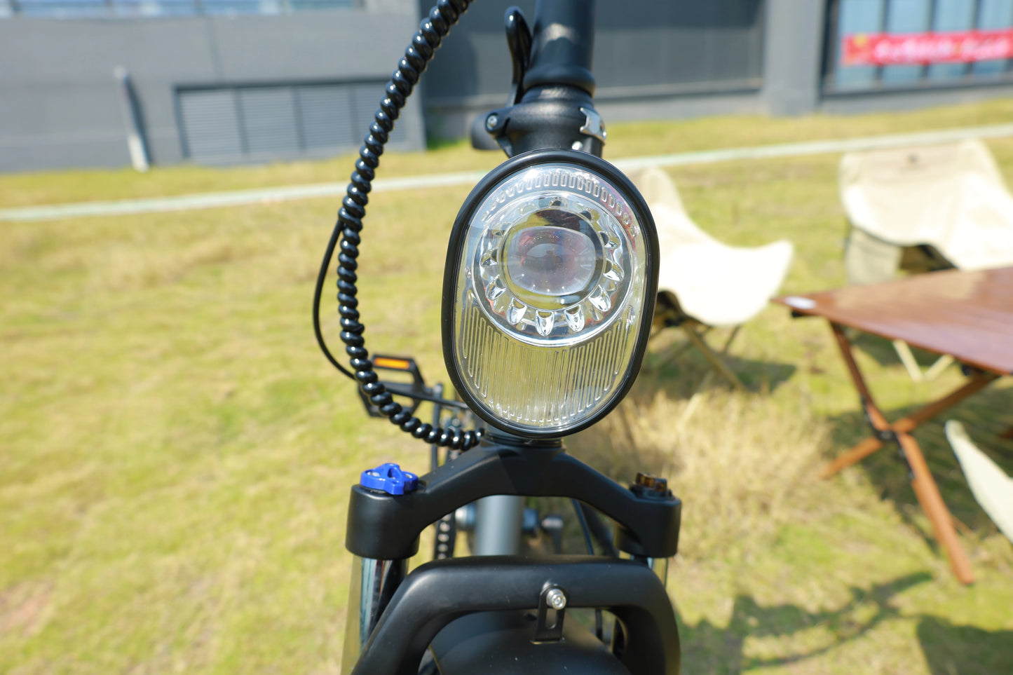Close-up of a bicycle headlight with a blurred background