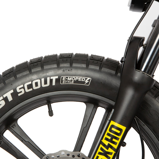 Close-up of a bicycle wheel with 'ST Scout' and 'KHS' branding on a white background