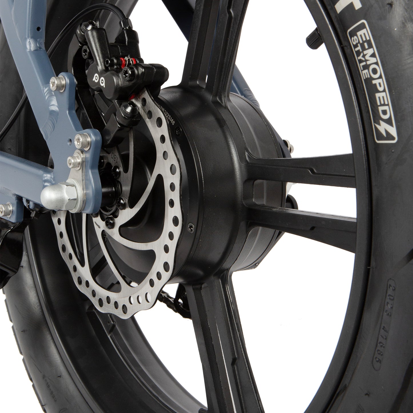 Close-up of a motorcycle wheel with disc brake and visible brand logo on a white background