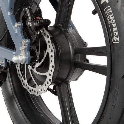 Close-up of a motorcycle wheel with disc brake and visible brand logo on a white background