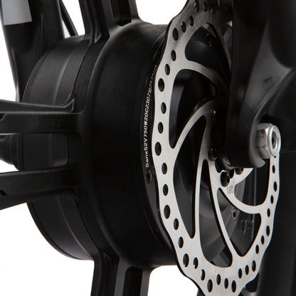 Close-up of a motorcycle disc brake with a white background