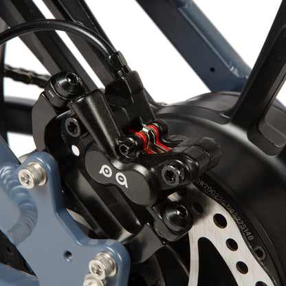 Close-up of a motorcycle brake system with 'PQ' branding.