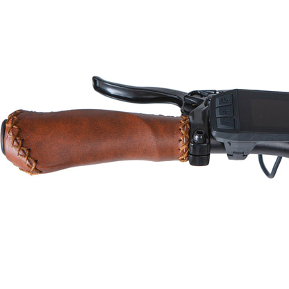 Close-up of a rifle with a brown leather stock on a white background
