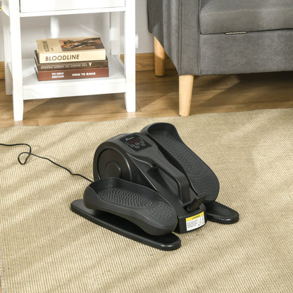 Black exercise on a carpeted floor with a couch and books in the background