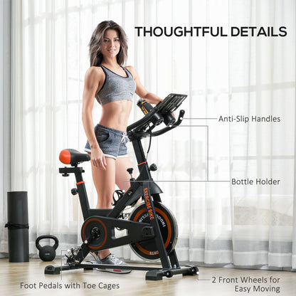 Woman using a stationary bike with labeled features in a home setting